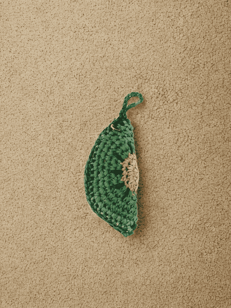 YZA raffia Kiwi Slice bag charm with golden tag, handmade in Marrakesh