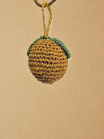 Load and play video in Gallery viewer, Whole Lemon bag charm, close-ups of stitching and light swing
