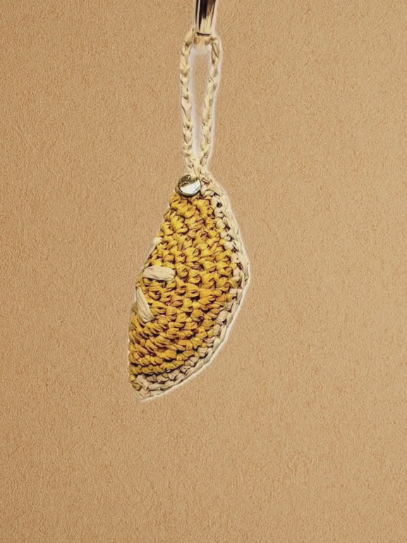 ideo of Lemon Slice charm being attached to a bag handle; close-ups of texture and finish