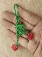 Load image into Gallery viewer, Cherries raffia charm held in hand, twin fruits visible
