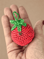 Load image into Gallery viewer, Tomato raffia charm in hand, red body with green top
