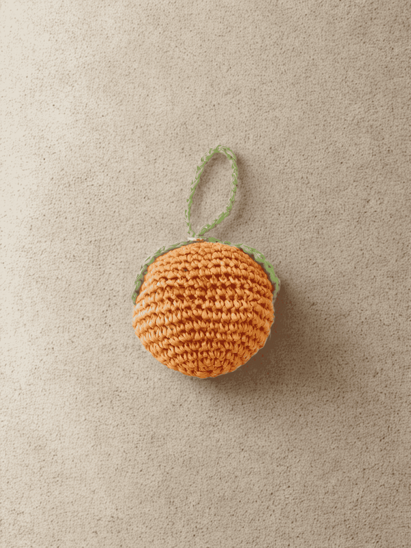 YZA hand-crocheted raffia Orange bag charm with golden tag, handmade in Marrakesh