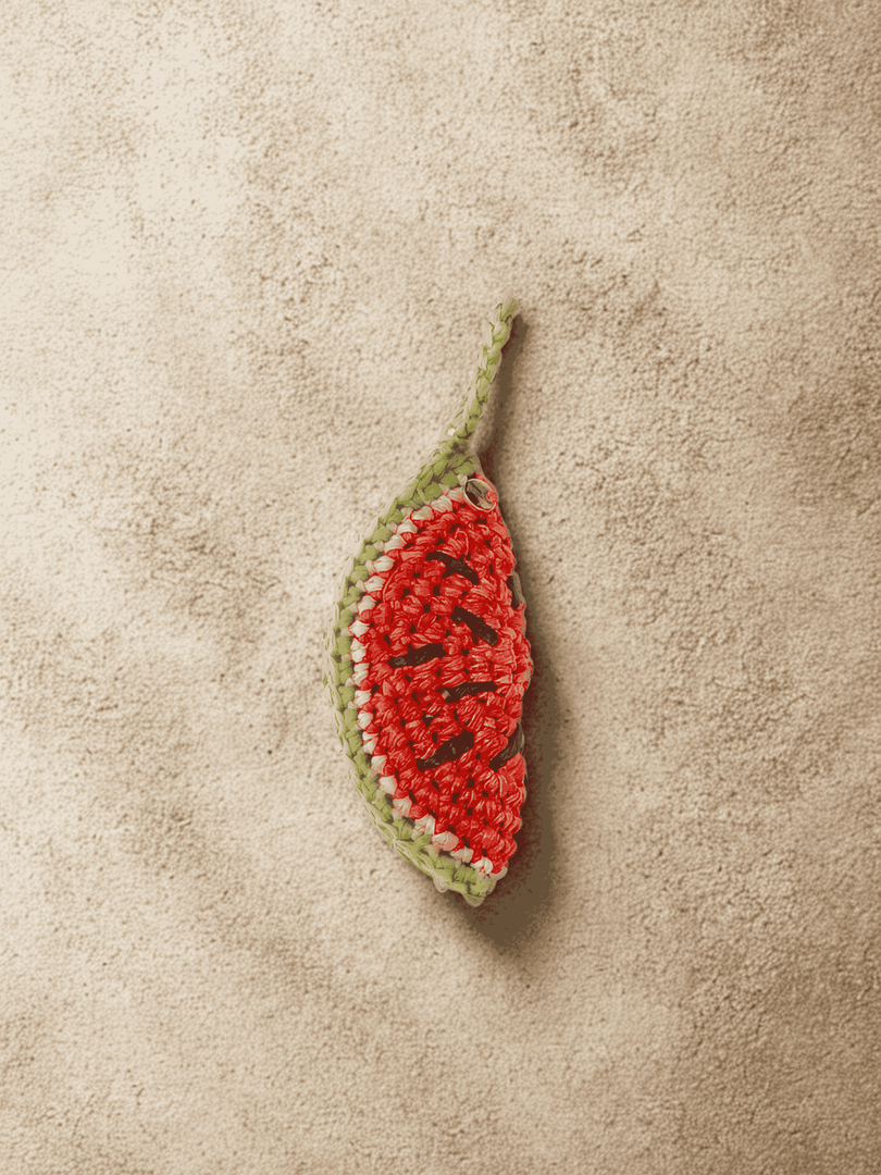 YZA hand-crocheted raffia Watermelon Slice bag charm with golden tag, handmade in Marrakesh